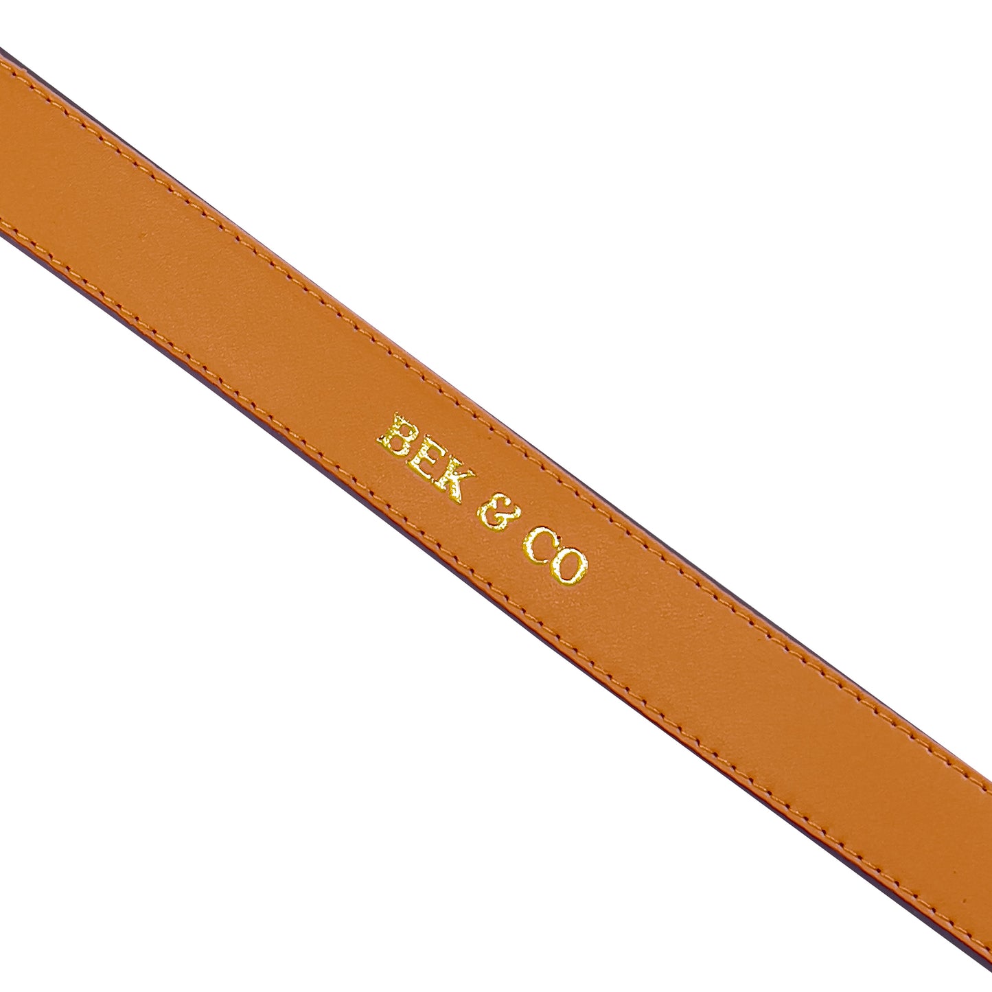 close up view of embossed Bek & Co logo on orange leather dog collar